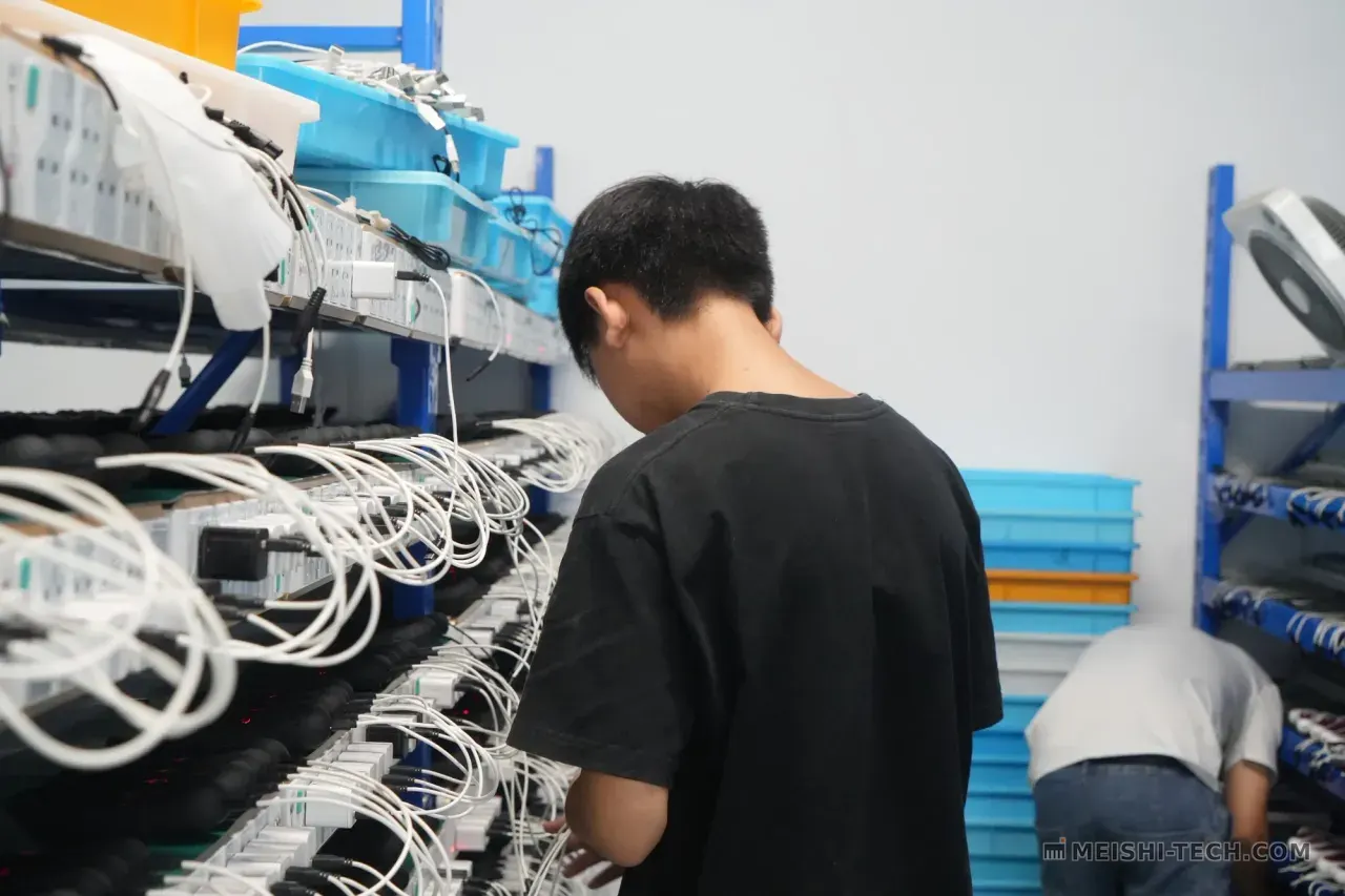 Worker performing charging test on hair clippers